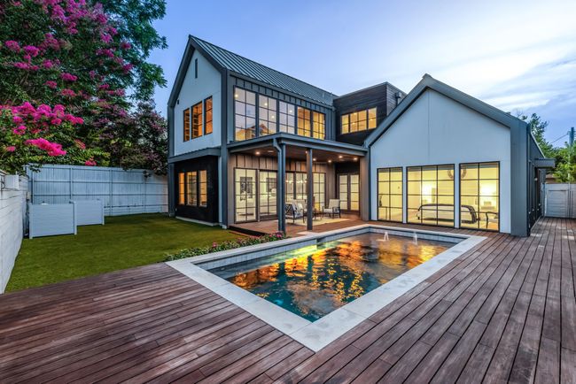 Back of property at dusk featuring a deck, a fenced backyard, and stucco siding | Image 35