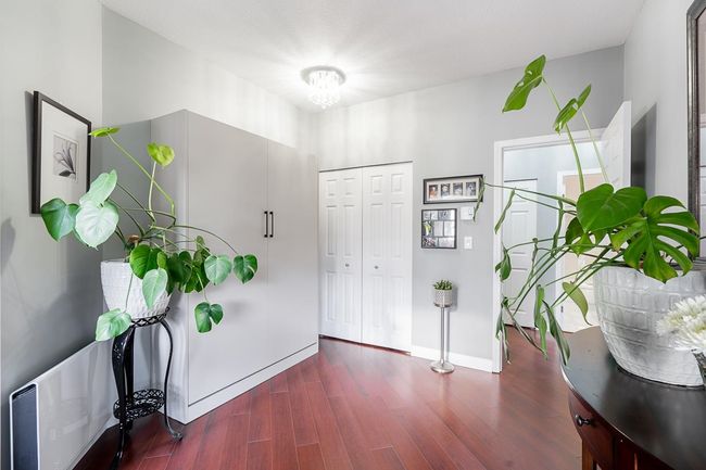 Entrance foyer featuring an inviting chandelier, wood finished floors, and baseboards | Image 22
