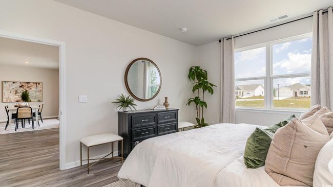 Bedroom featuring wood finished floors, baseboards, and multiple windows | Image 16