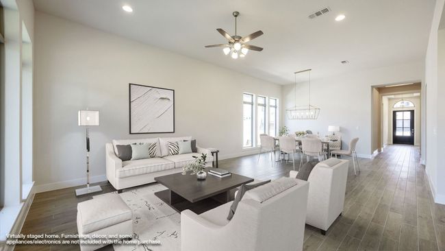 Living area featuring healthy amount of natural light, a ceiling fan, wood finished floors, baseboards, and recessed lighting | Image 4