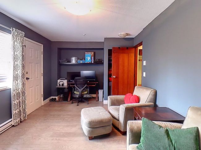 Interior space with a baseboard heating unit and wood finished floors | Image 23