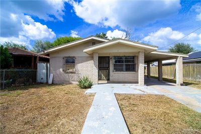 View of front of home featuring a front yard and a carport | Image 1