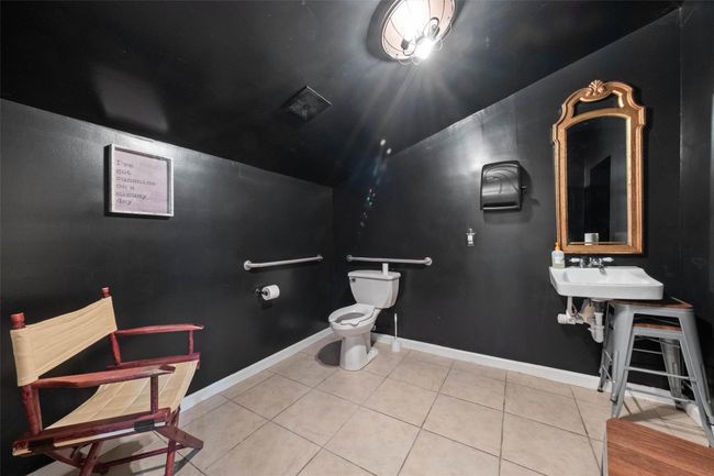 Bathroom featuring lofted ceiling, baseboards, tile patterned flooring, and toilet | Image 13