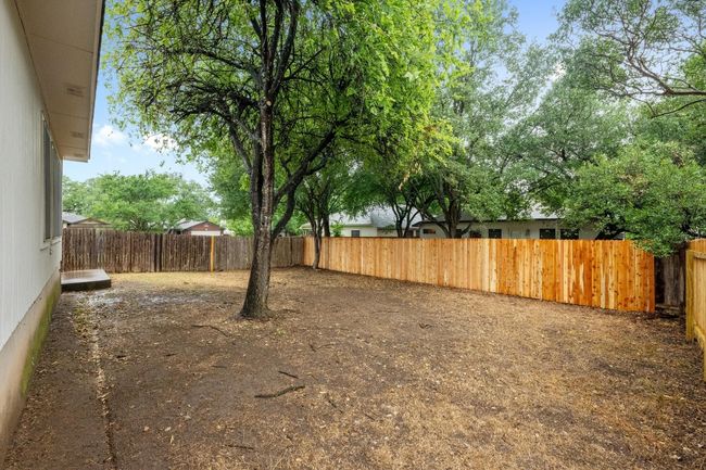 View of fenced backyard. | Image 24