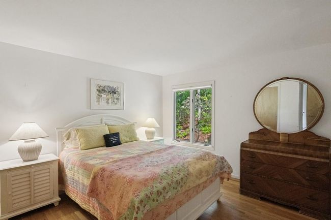 Bedroom featuring wood finished floors and baseboards | Image 12