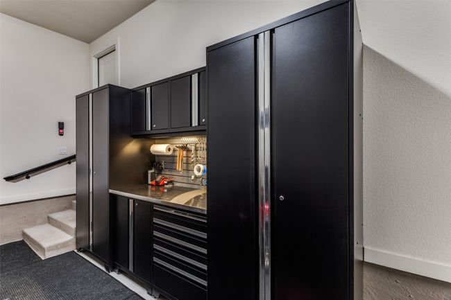 Indoor bar with decorative backsplash and stairway | Image 33