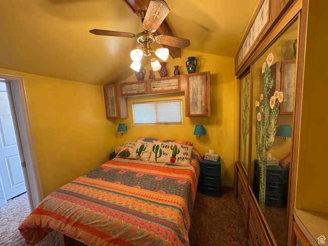 Carpeted bedroom with lofted ceiling and a ceiling fan | Image 14