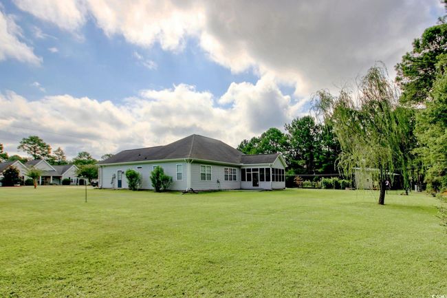View of grassy yard featuring a sunroom | Image 27