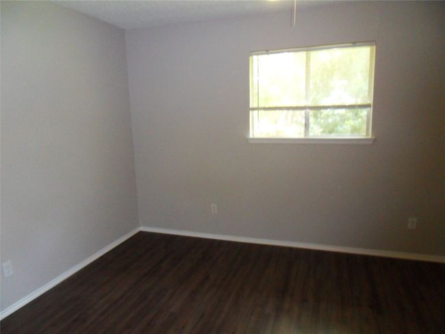 Spare room featuring dark wood finished floors and baseboards | Image 14
