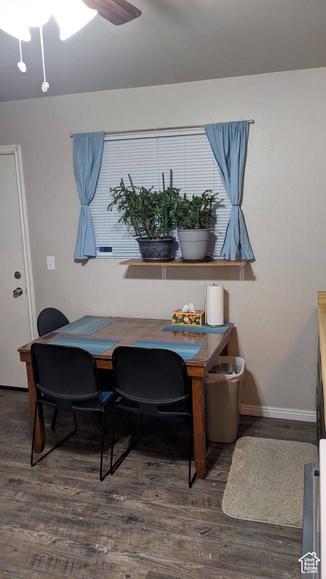 Dining area with wood finished floors, baseboards, and ceiling fan | Image 10