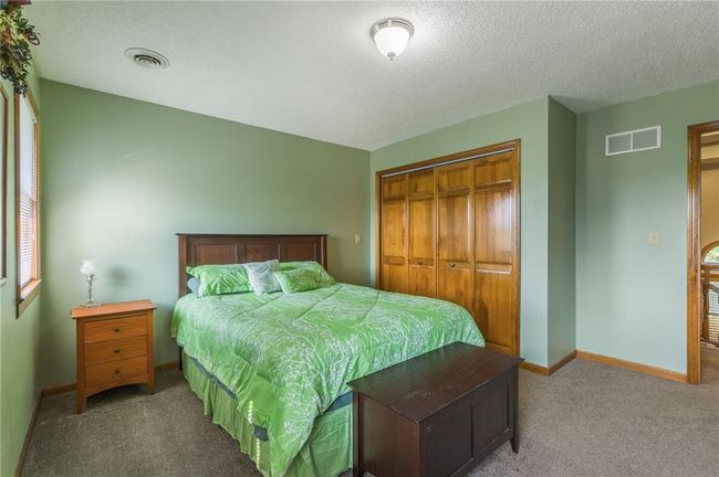 Bedroom featuring baseboards, carpet flooring, a closet, and visible vents | Image 51