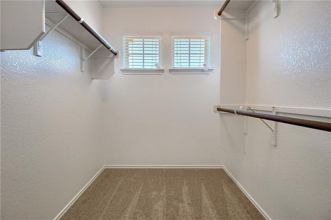 Spacious closet with carpet floors | Image 25