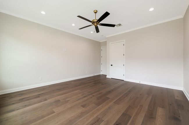 Spare room featuring dark wood-type flooring, a ceiling fan, recessed lighting, and crown molding | Image 40