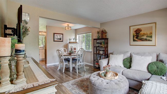 Dining space with wood finished floors and baseboards | Image 5