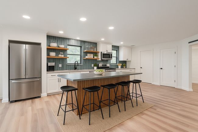 Kitchen featuring appliances with stainless steel finishes, open shelves, light wood finished floors, tasteful backsplash, and recessed lighting | Image 11