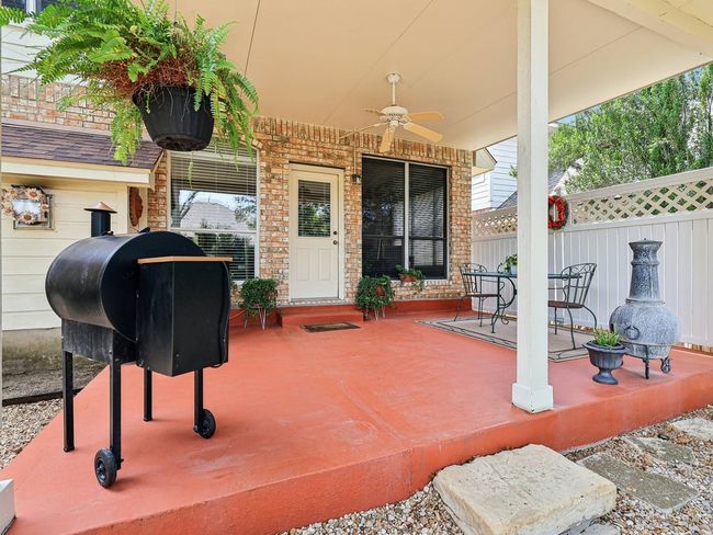 View of patio with ceiling fan and fence | Image 31