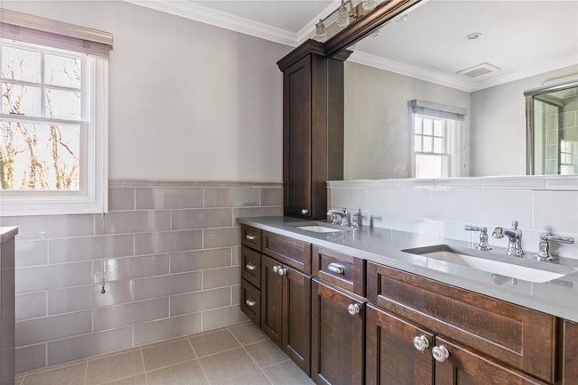 Bathroom featuring crown molding, a sink, and double vanity | Image 36
