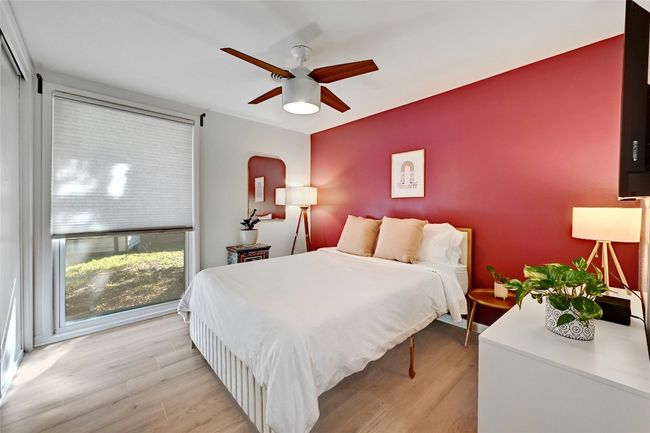 Another nice-sized bedroom with a ceiling fan and electric window shades. | Image 23
