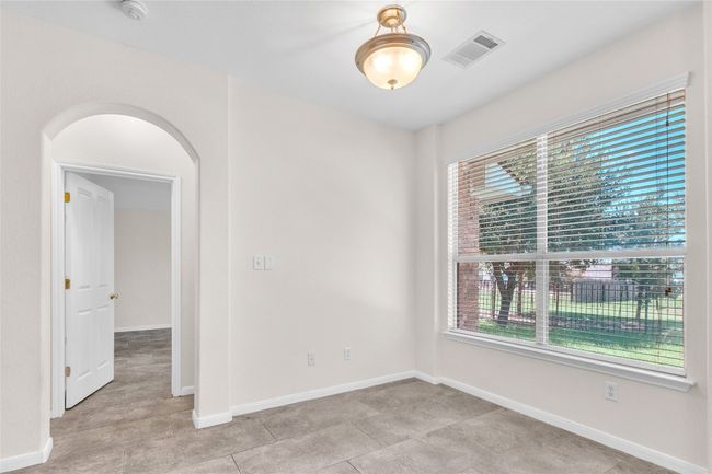 Unfurnished room with baseboards and arched walkways | Image 13