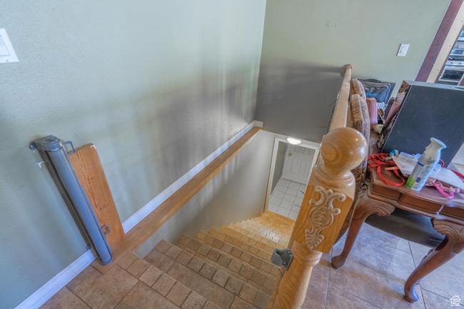Stairs with baseboards and tile patterned floors | Image 43