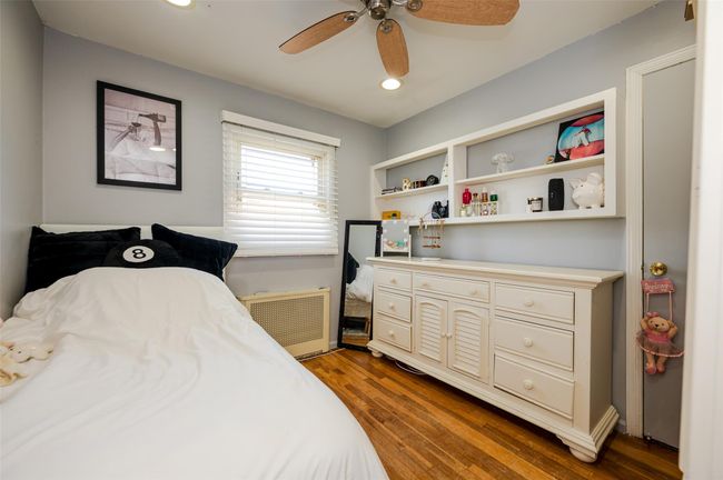 Bedroom with radiator, recessed lighting, ceiling fan, and dark wood-type flooring | Image 12
