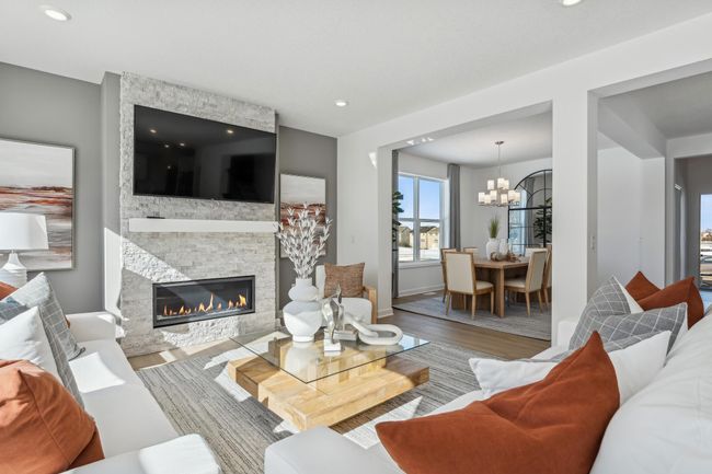 Photo is of the actual model. The spacious family gathering area seamlessly connects to the kitchen area. It also features many large windows providing warm natural light! | Image 9
