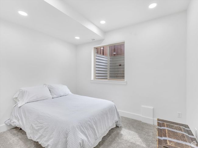 Carpeted bedroom featuring baseboards, visible vents, and recessed lighting | Image 34
