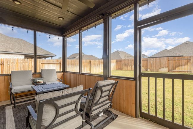 Enclosed/screened in patio with roll down shades for privacy. | Image 21