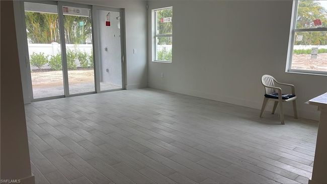 Great room with tray ceiling and copious amounts of natural light | Image 10