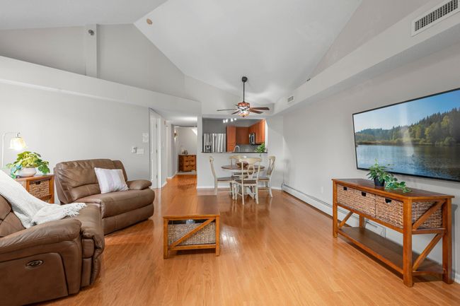 A different view of the living room and dining area. | Image 7