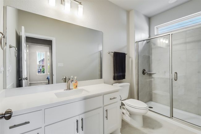 Bathroom with toilet, a shower stall, vanity, and healthy amount of natural light | Image 33