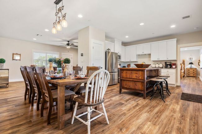 Dining space featuring light wood finished floors, a ceiling fan, recessed lighting, and baseboards | Image 33