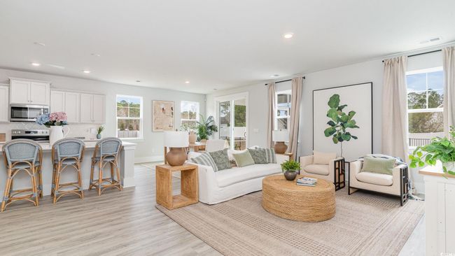 Living area featuring healthy amount of natural light, recessed lighting, light wood-style floors, and baseboards | Image 7