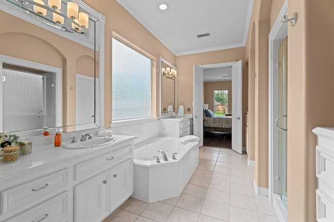 Light & bright! This lovely primary ensuite offers relaxation and serenity. | Image 21