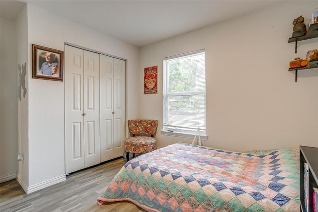 Bedroom featuring vinyl flooring and a closet | Image 19