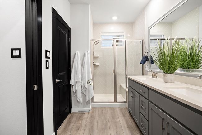 Bathroom with a shower stall, double vanity, and light wood finished floors | Image 17