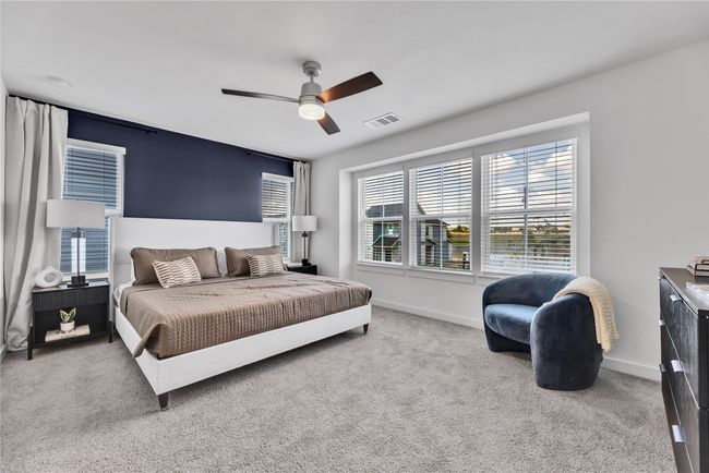 Bedroom featuring baseboards, visible vents, ceiling fan, and carpet flooring | Image 12