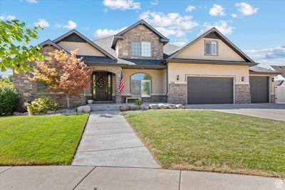 View of front of home featuring a garage and a front lawn | Image 1