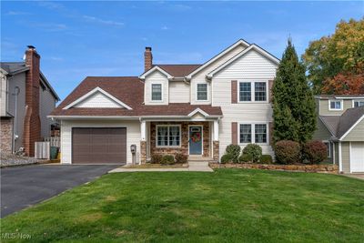 View of front facade with cooling unit and a front yard | Image 1