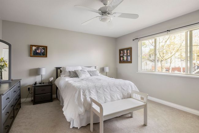 Bedroom with light carpet, baseboards, and ceiling fan | Image 15