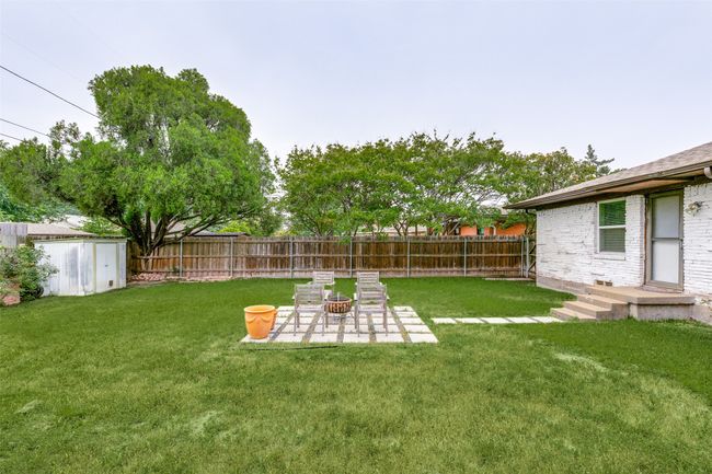 Fenced backyard with a patio and a storage unit | Image 22