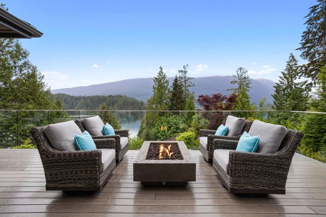 Wooden deck featuring a water and mountain view, an outdoor living space with a fire pit, and a wooded view | Image 4