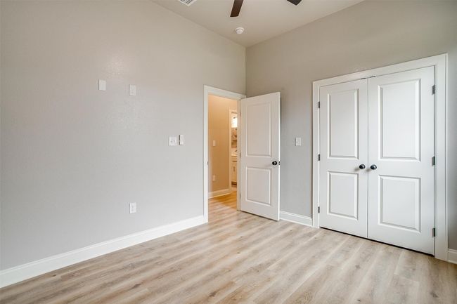 Unfurnished bedroom featuring baseboards, ceiling fan, a closet, and light wood-style flooring | Image 26