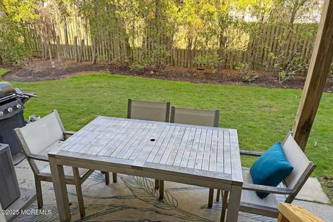 Enjoy serene al fresco dining on your private patio - an ideal way to end the perfect beach day. | Image 9