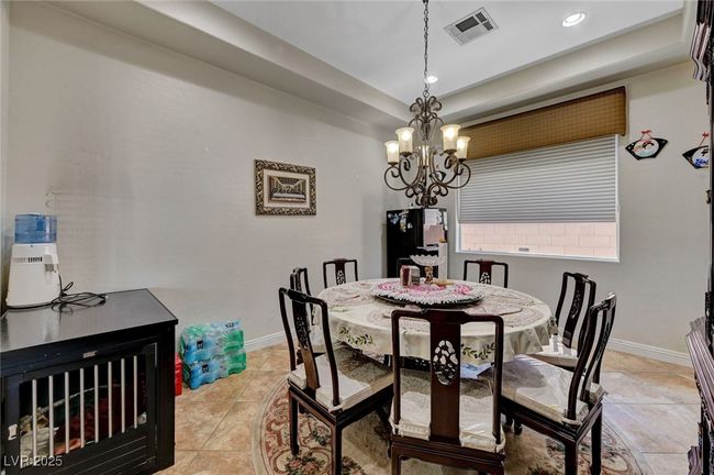 Dining space featuring a chandelier, recessed lighting, and light tile patterned flooring | Image 24