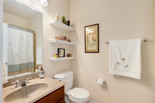 Full bathroom featuring toilet, vanity, and a shower with shower curtain | Image 17