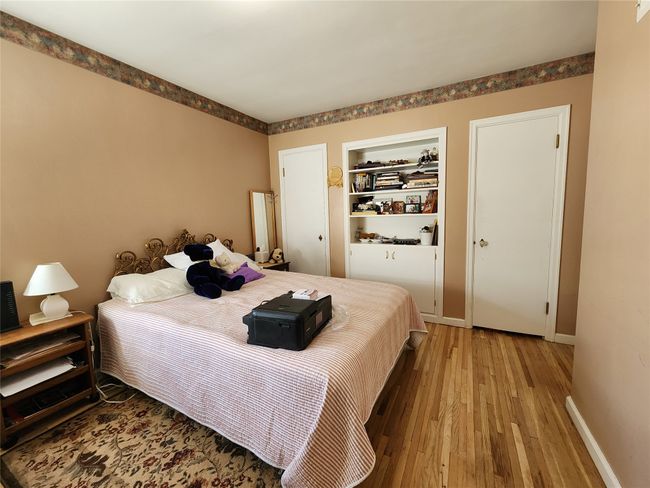 Bedroom featuring baseboards and wood finished floors | Image 29