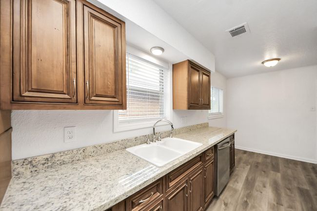 Updated kitchen with beautiful countertops and solid wood cabinets. | Image 14