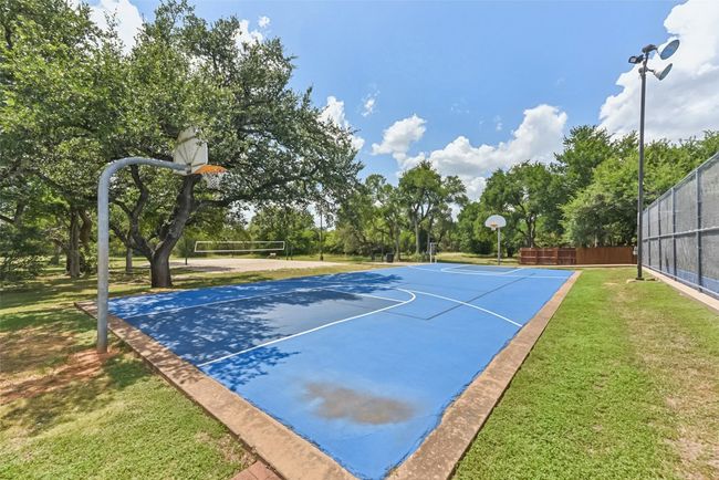 View of HOA basketball court featuring volleyball court, and view of wooded area | Image 40