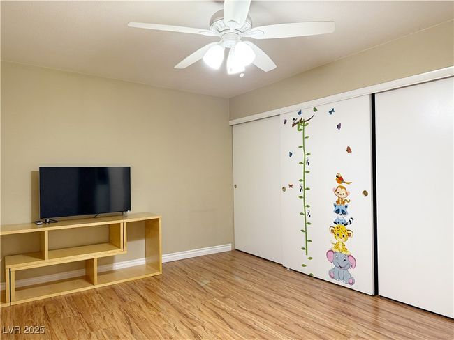 Unfurnished living room featuring wood finished floors, a ceiling fan, and​​‌​​​​‌​​‌‌​‌‌​​​‌‌​​‌‌​‌​​​​​‌ baseboards | Image 14